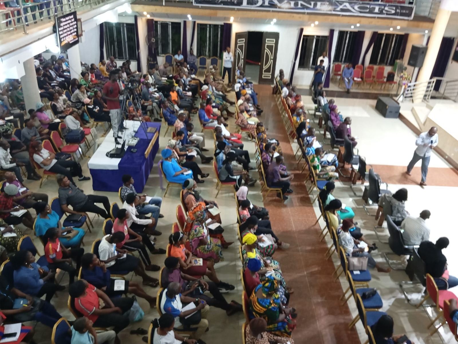 View from the balcony over a full conference hall