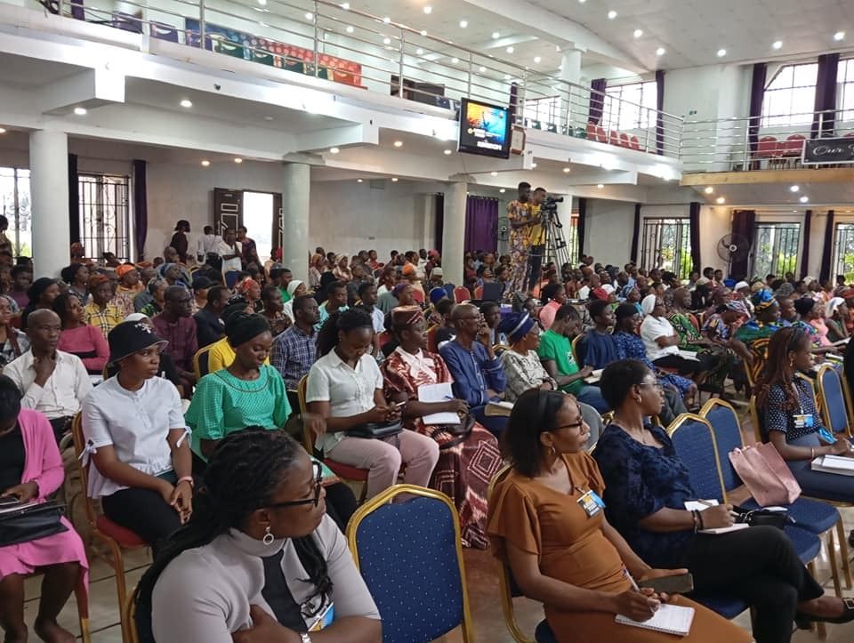 A full hall of delegates seated for a session