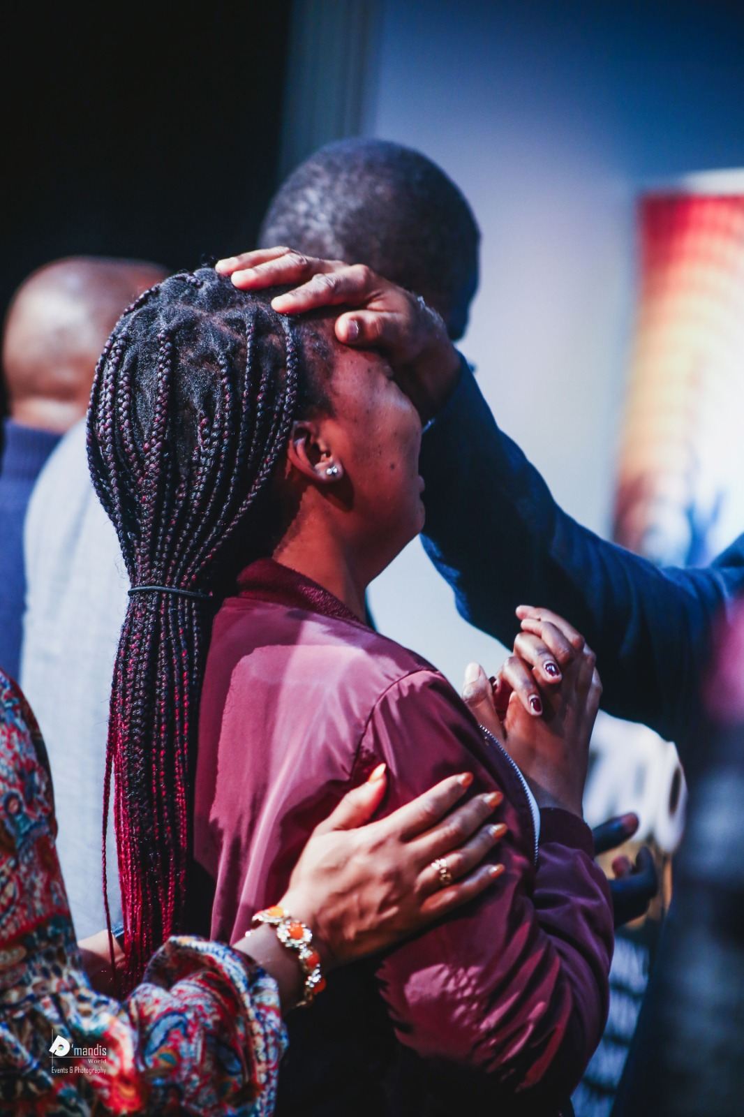 A woman embraced and comforted during prayer