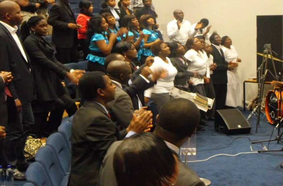 Delegates worshipping beside the band